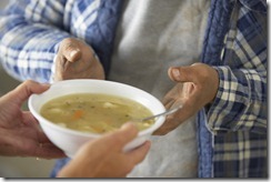 Hands of Homeless Man Receiving Bowl of Soup --- Image by © Royalty-Free/Corbis